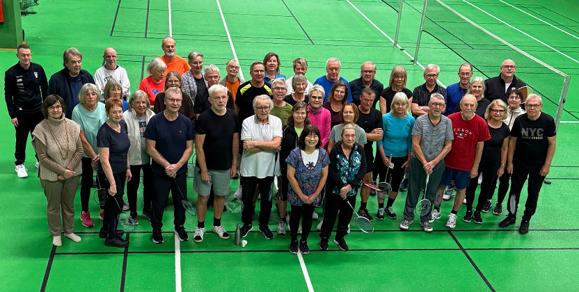 En grupp med människor i en badminton hall.